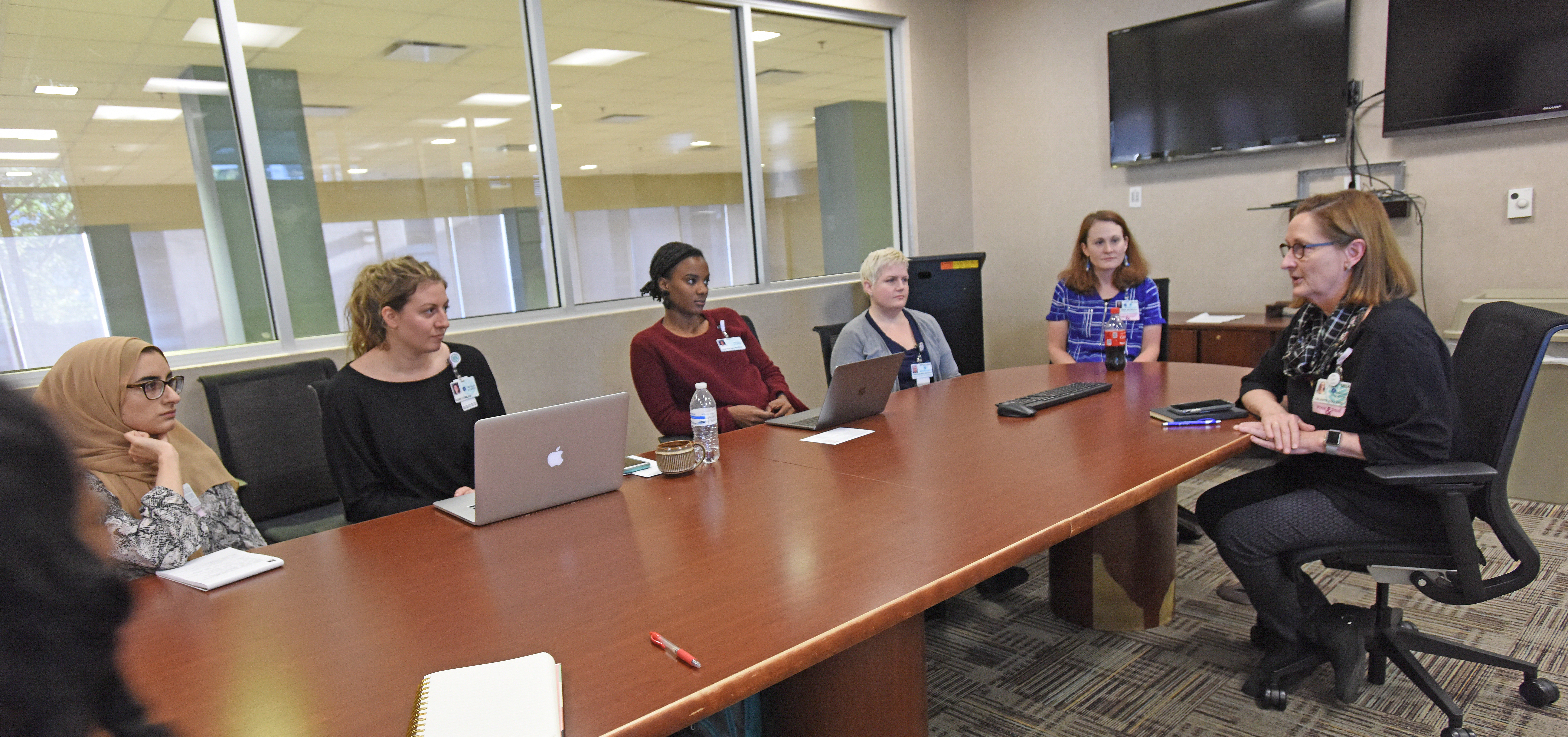 Students and faculty hold a debriefing after Pulse Weekend