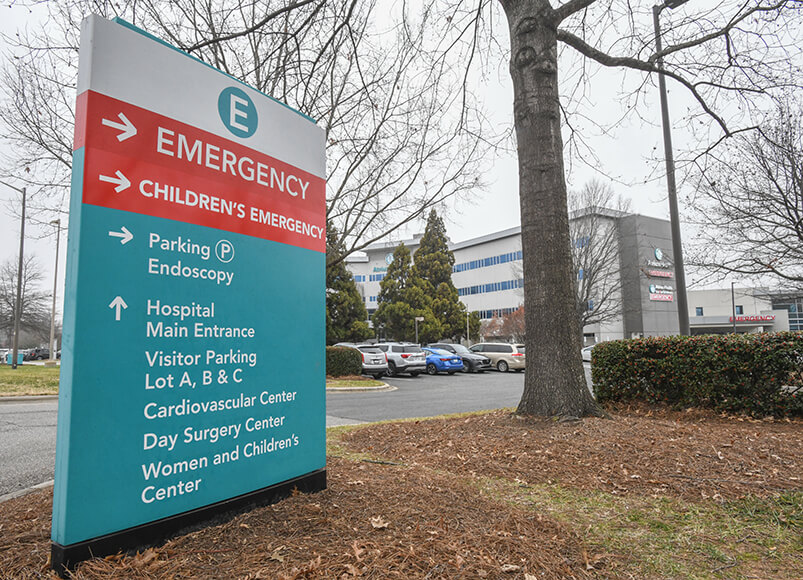 A sign for a hospital and emergency room depicting where to find specific services within the facility.