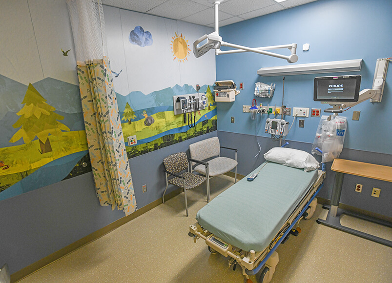 A hospital room complete with a bed and chairs for visitors.