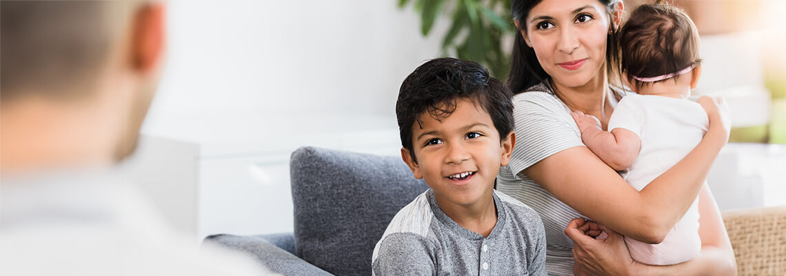 Mom With Young Children Meets With Doctor